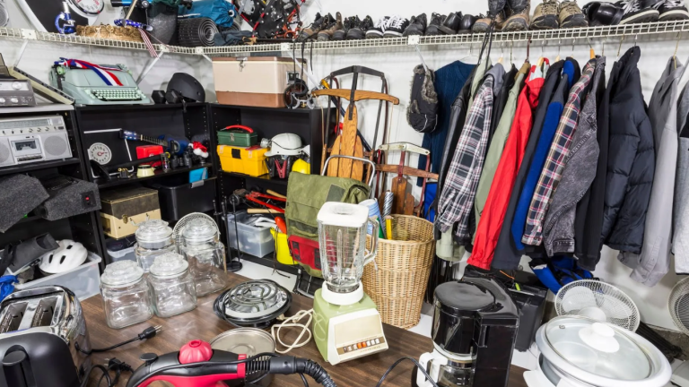 A room filled with clothes and kitchenware for hoarding cleanup services
