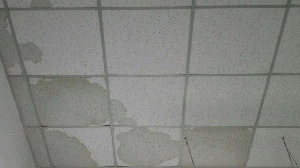 water damage visible above the ceiling